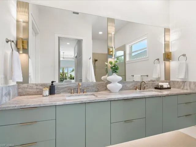 Primary bath with dual vanities and custom cabinetry