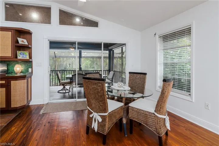 Dining area with sliders out to screened-in lanai