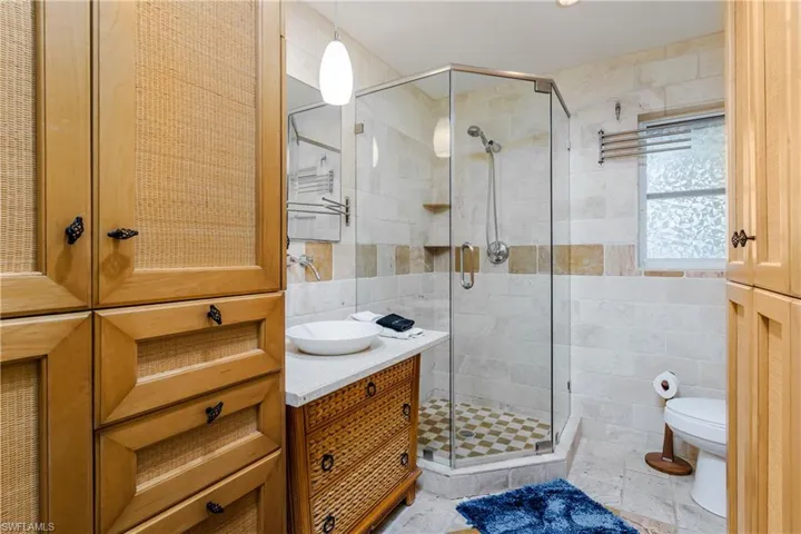 Very custom main bathroom with tiled floor and walls.