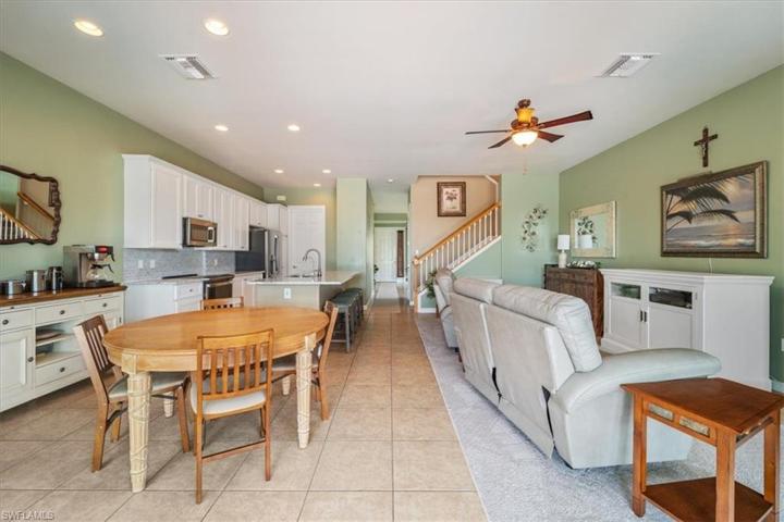 Living area view to front entry, family room, breakfast nook and kitchen