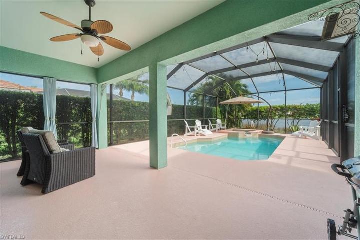 Beautifully maintained screened in pool with private lush landscaping and long lake views