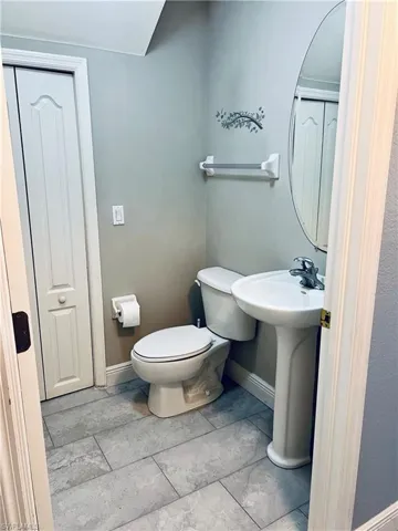 Bathroom featuring tile floors and toilet