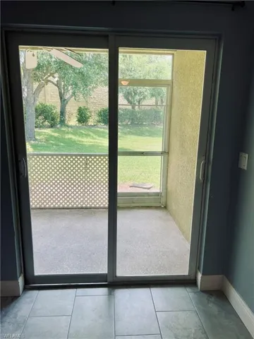 Doorway featuring tile flooring and plenty of natural light