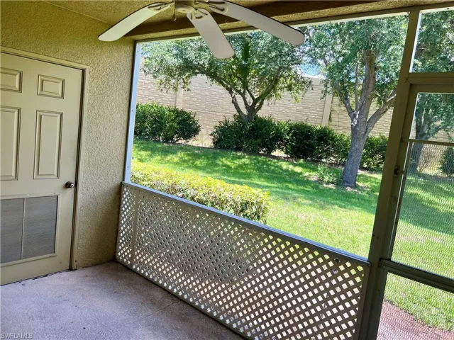 Unfurnished sunroom with ceiling fan
