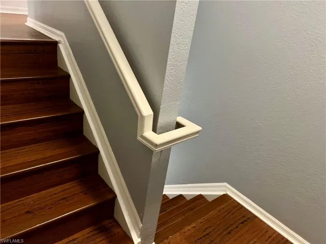 Stairway with dark hardwood / wood-style flooring