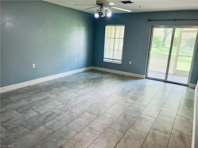 Spare room with tile floors and ceiling fan