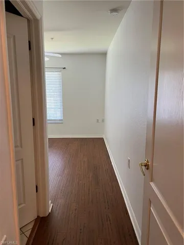 Hallway with dark wood-type flooring