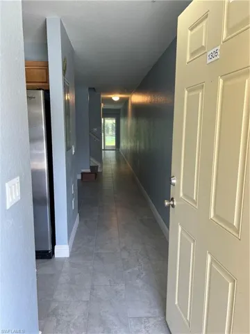 Hallway with tile flooring