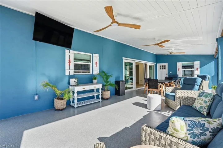 View of patio / terrace with outdoor lounge area, outdoor dining space, and ceiling fan - Virtually Edited Image