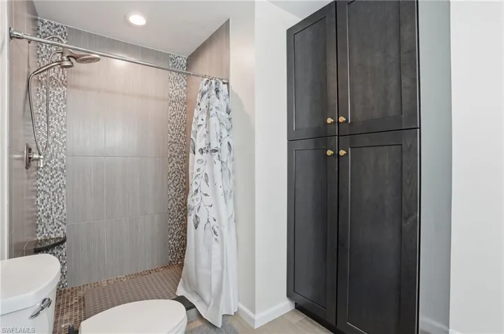 Bathroom with a stall shower and toilet - Virtually Edited Image