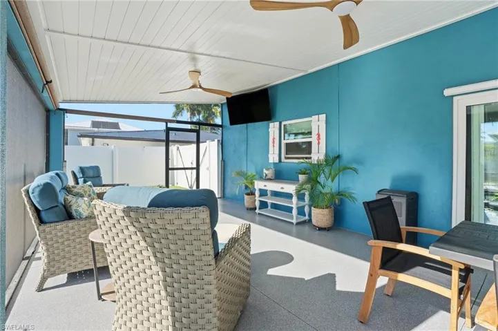 Sunroom featuring ceiling fan and outdoor lounge area - Virtually Edited Image