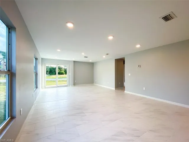 Spare room featuring recessed lighting and baseboards
