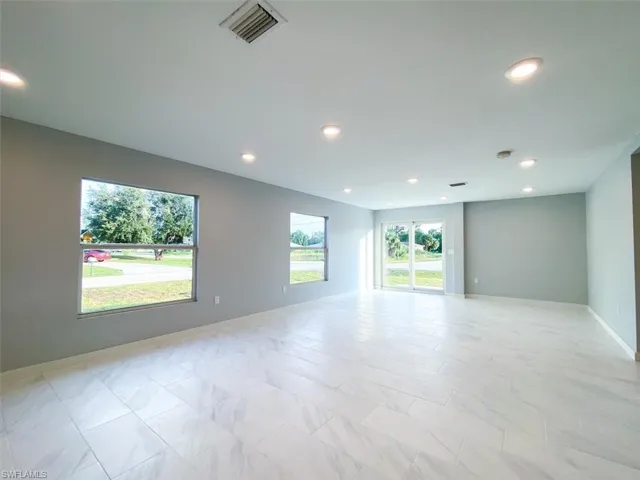 Unfurnished room with baseboards and recessed lighting