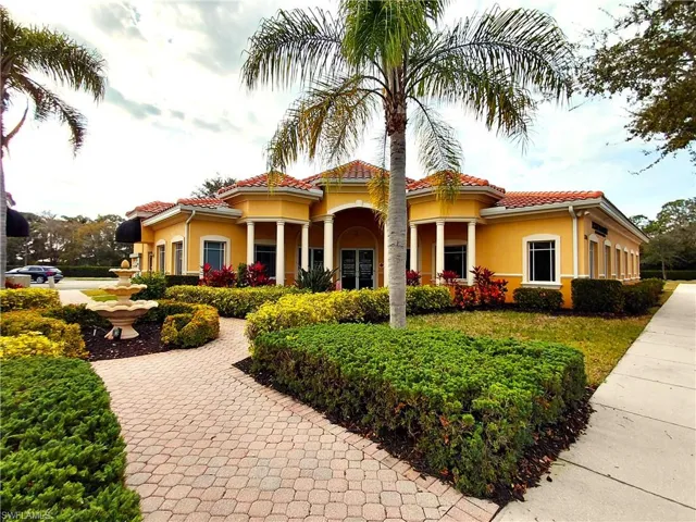 View of front facade featuring stucco siding and a tiled roof
