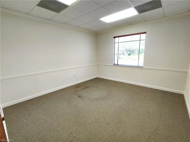 Room 2 with crown molding and a drop ceiling