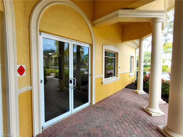 Entrance to property with stucco siding and covered porch