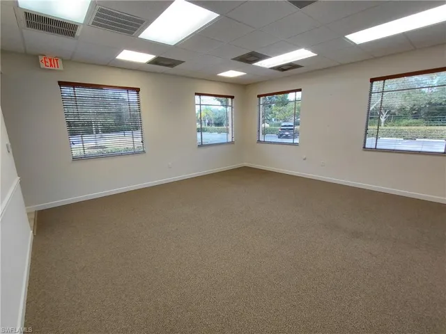"Large" room 4 Carpeted room featuring a paneled ceiling and healthy amount of natural light