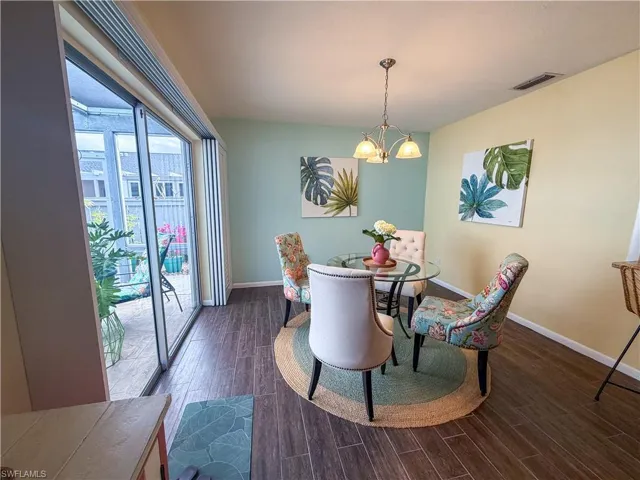 Dining room featuring wood finish floors and a chandelier
