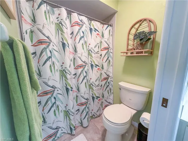 Bathroom featuring a shower with curtain and tile patterned floors