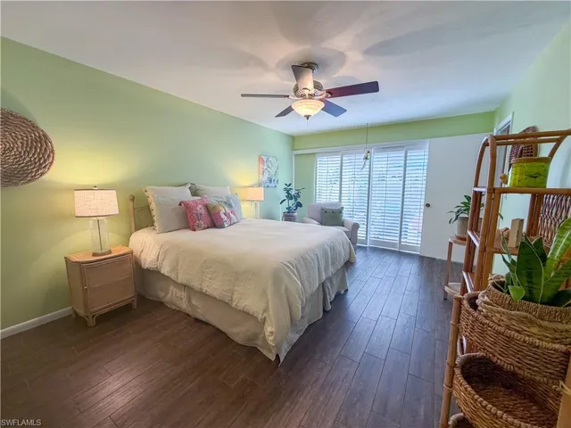 Bedroom featuring dark wood-style floors and a ceiling fan