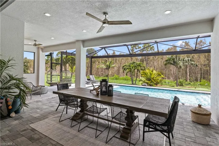 Under truss outdoor lanai with fully screened pool mansard cage.