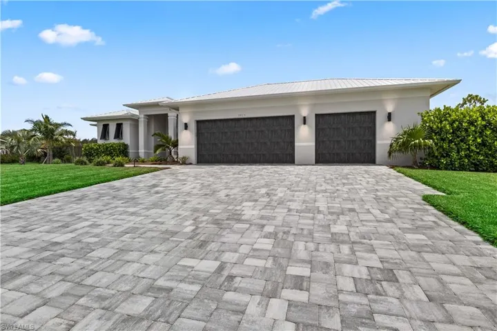 Custom built home featuring lush landscape and an over sized 3 car garage