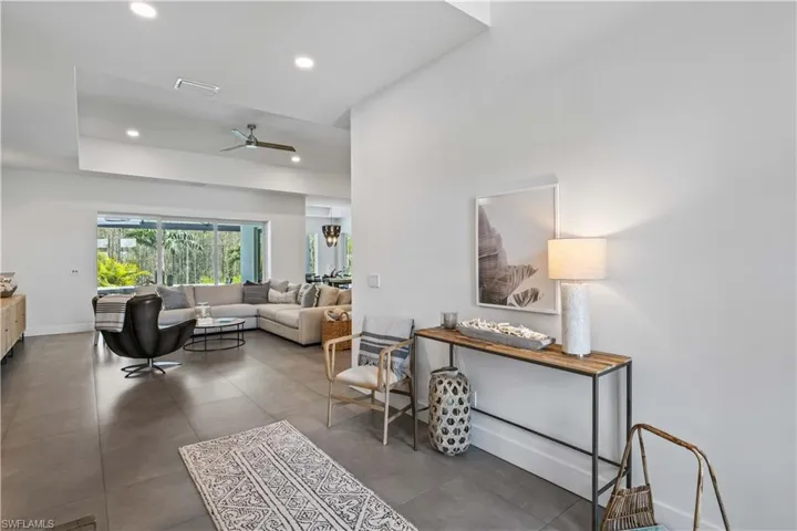 Living room featuring tile flooring and ceiling fan