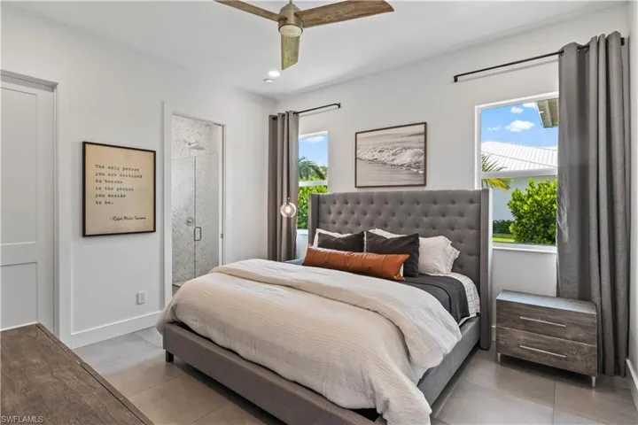 Tiled bedroom Flooring featuring ceiling fan