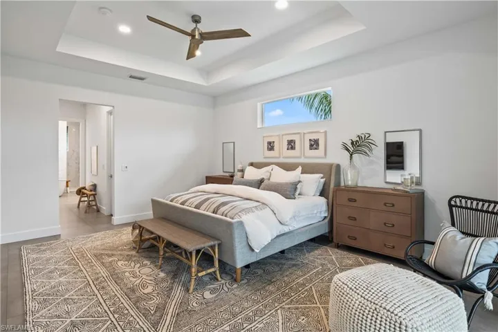 Bedroom featuring ceiling fan and a raised ceiling