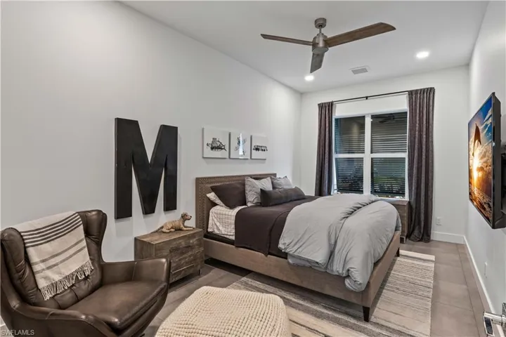Bedroom with tile floors and ceiling fan