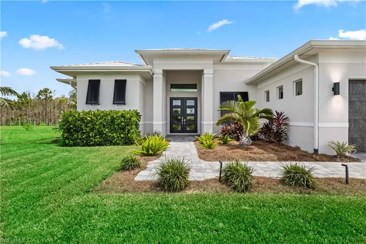 View of front of home featuring a front yard and french doors