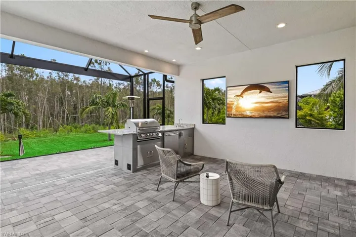 View of patio featuring grilling area under truss.