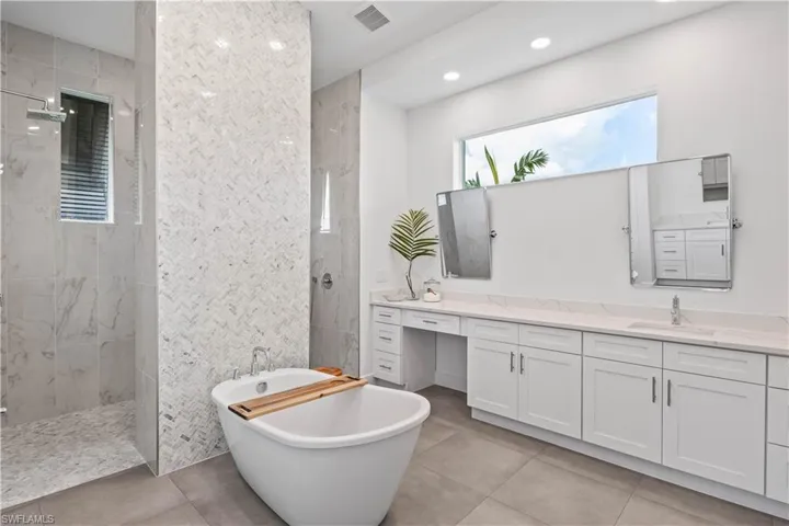 Bathroom with tile flooring, independent shower and Soaker bath, and dual vanities