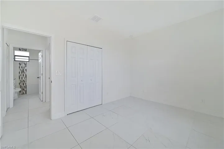 Unfurnished bedroom featuring baseboards and a closet