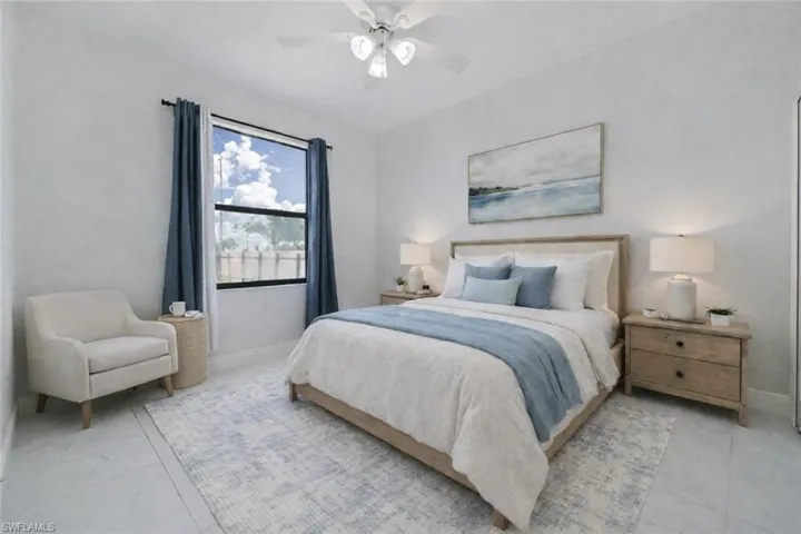 Virtually staged bedroom featuring a ceiling fan and large window
