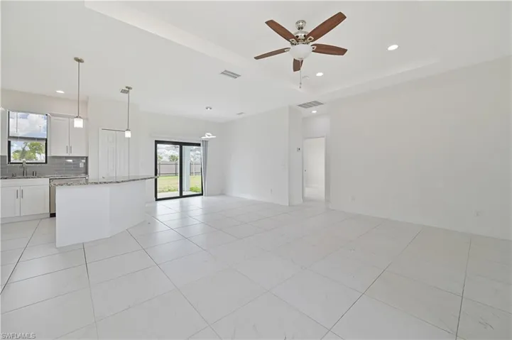 Living room with a ceiling fan and recessed lighting