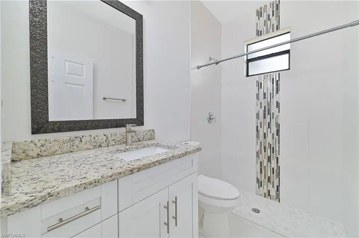 Bathroom featuring vanity and a shower stall
