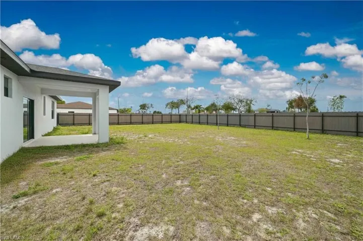 Fenced backyard with a patio