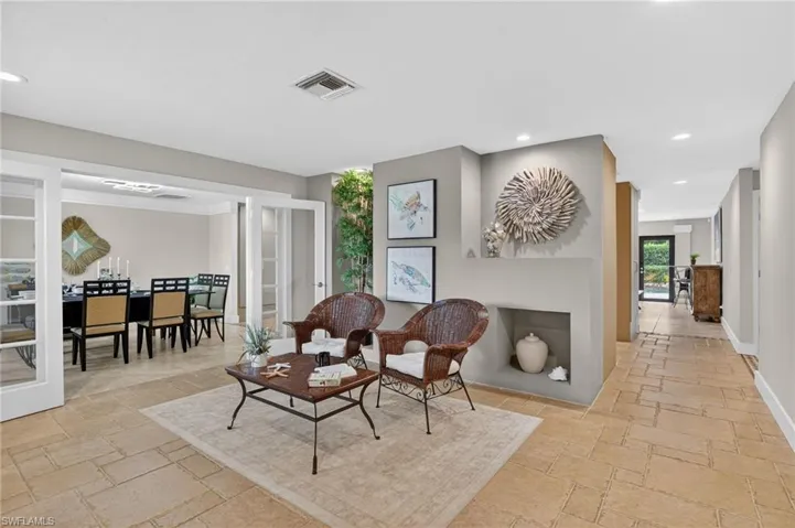 Sitting room with stone tile flooring and recessed lighting