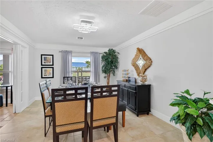 Dining space featuring a textured ceiling and light tile patterned floors