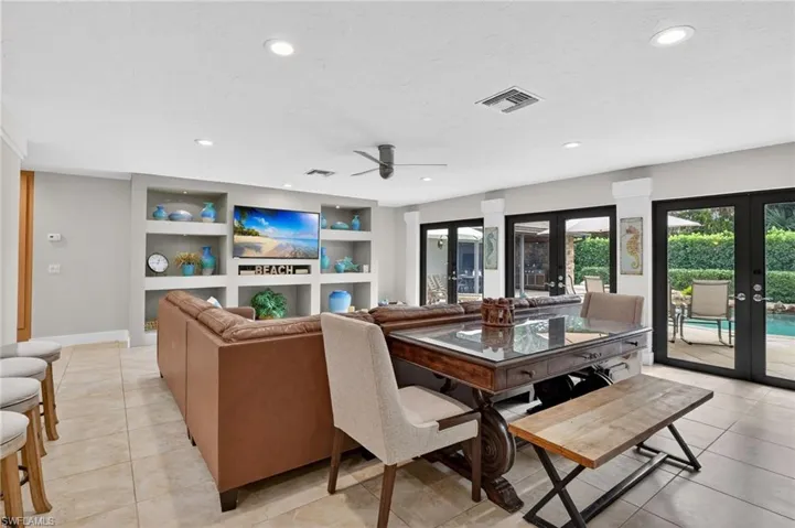 Dining space with built in shelves, french doors, a ceiling fan, light tile patterned floors, and recessed lighting