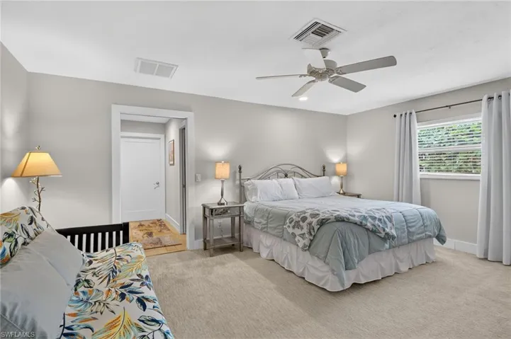 Bedroom featuring a ceiling fan and light colored carpet