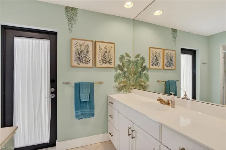 Full bathroom featuring vanity, recessed lighting, and light tile patterned floors