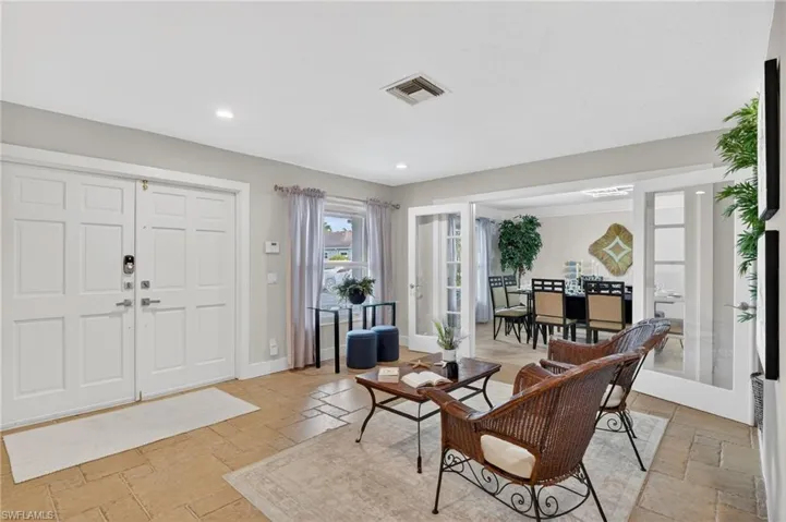 Entryway with stone tile flooring, recessed lighting, and french doors