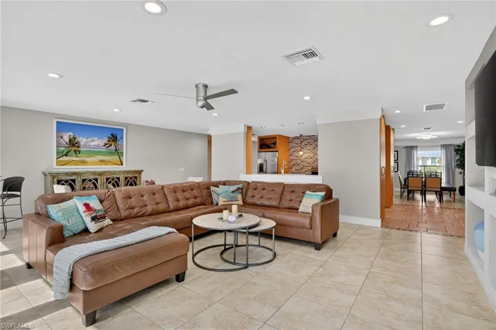 Living room featuring recessed lighting, a ceiling fan, and light tile patterned floors