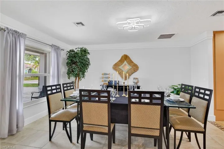 Dining space with a textured ceiling and light tile patterned floors