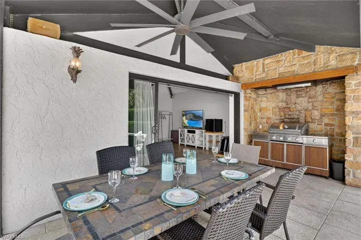 View of patio / terrace featuring outdoor dining area and an outdoor kitchen