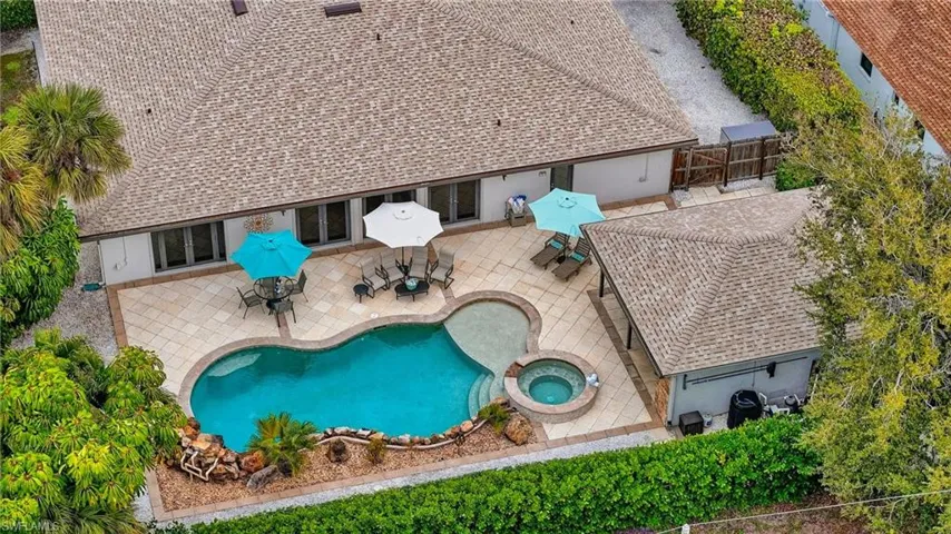 View of swimming pool with a patio area, a fenced backyard, a pool with connected hot tub, and grilling area