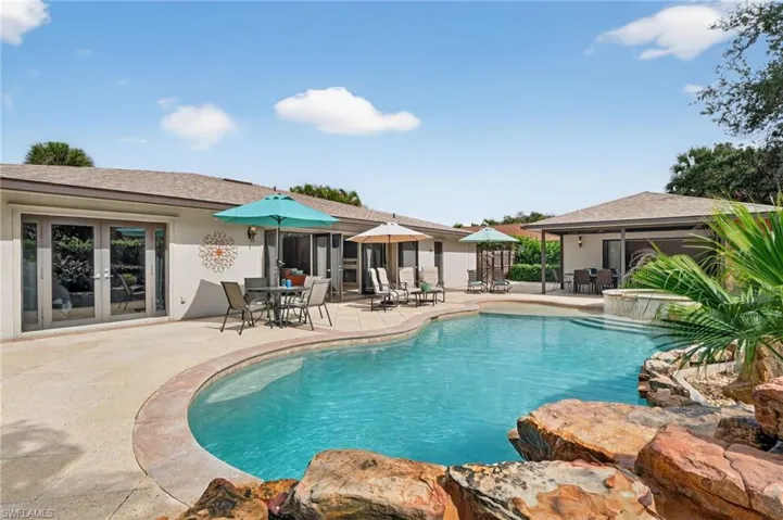 Outdoor pool with a patio area, french doors, and outdoor dining space