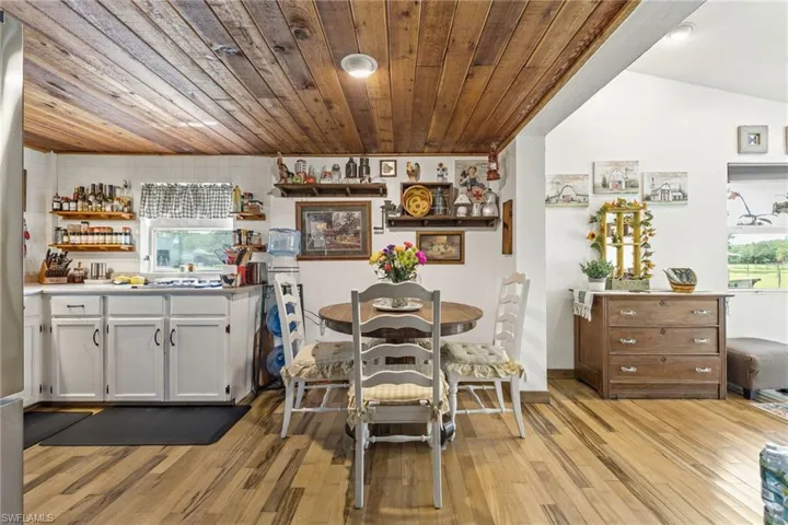 Dining room with wooden ceiling and light wood finished floors